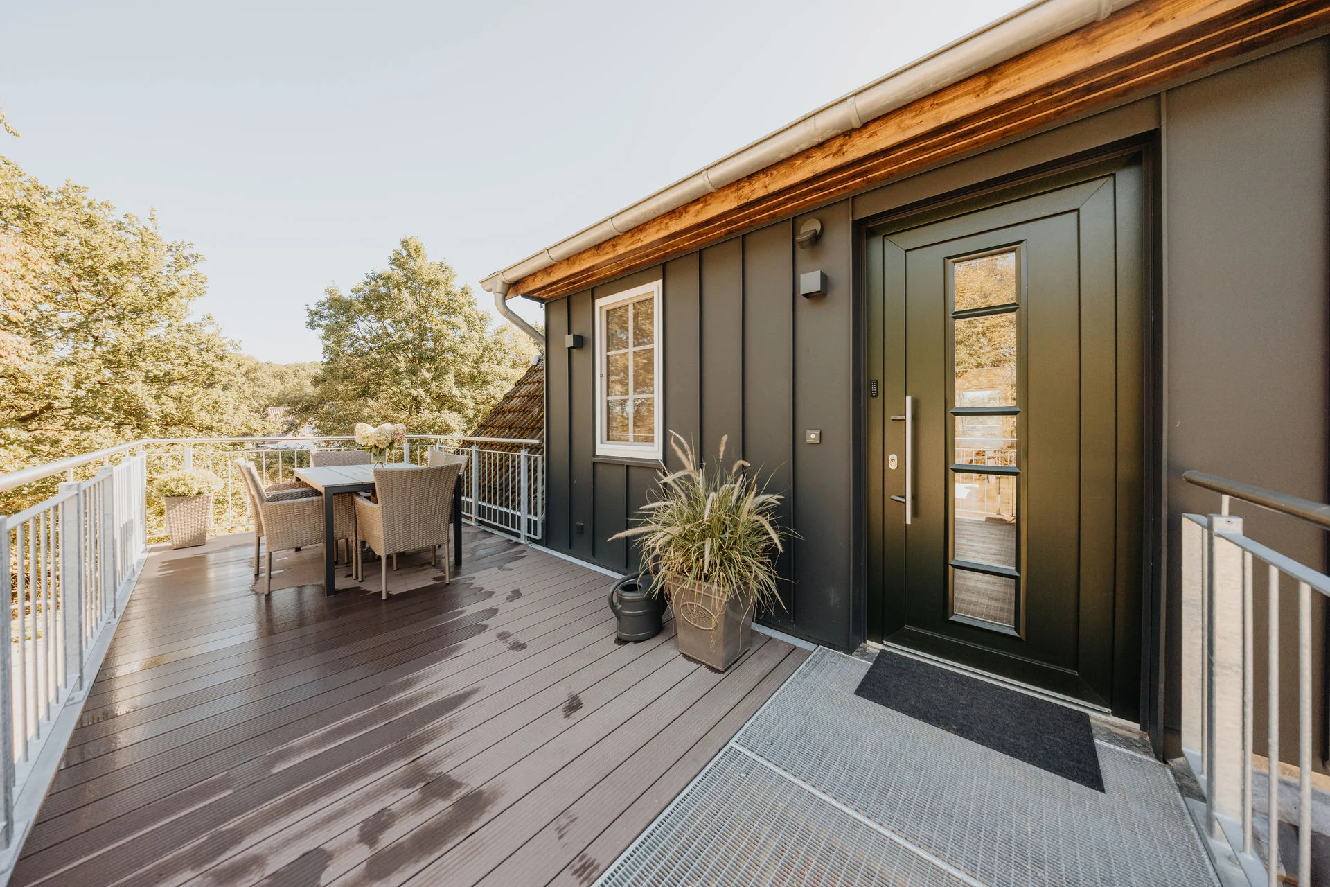 HeidePanorama: Balkon mit Sitzgruppe neben der grünen Eingangstür